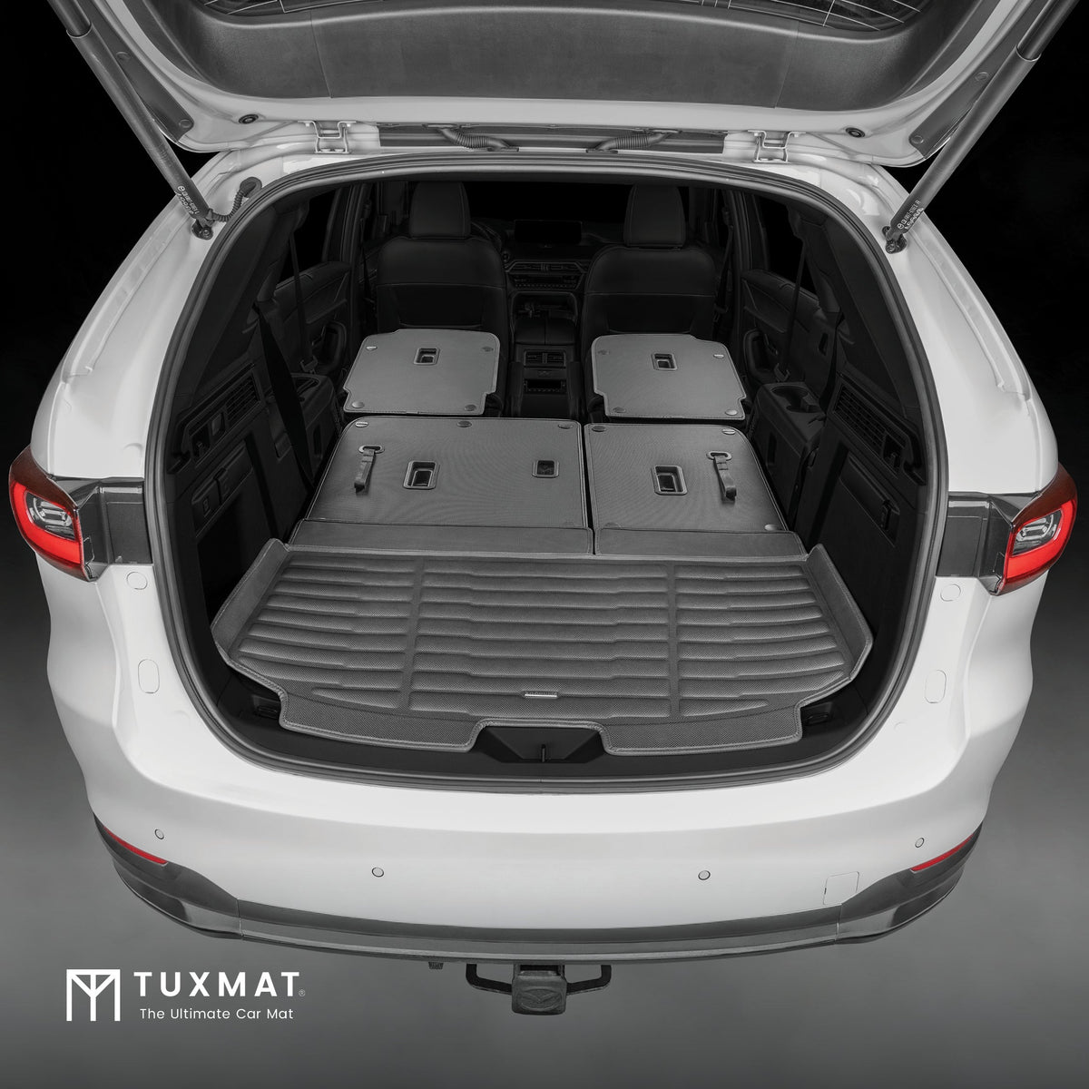 Open car trunk with a TuxMat car mat installed, showing the product's fit and design.