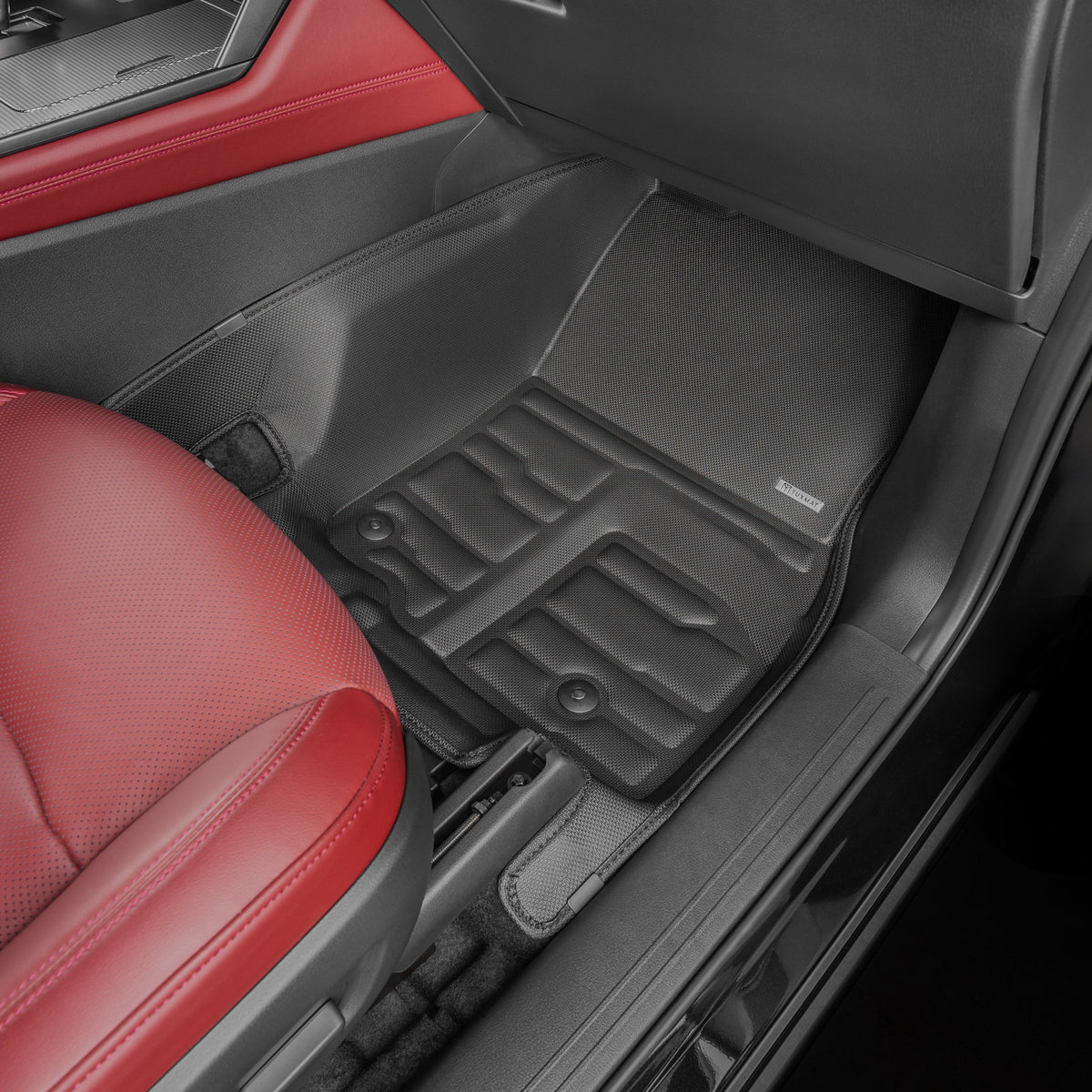 Car interior with black floor mats and red seat