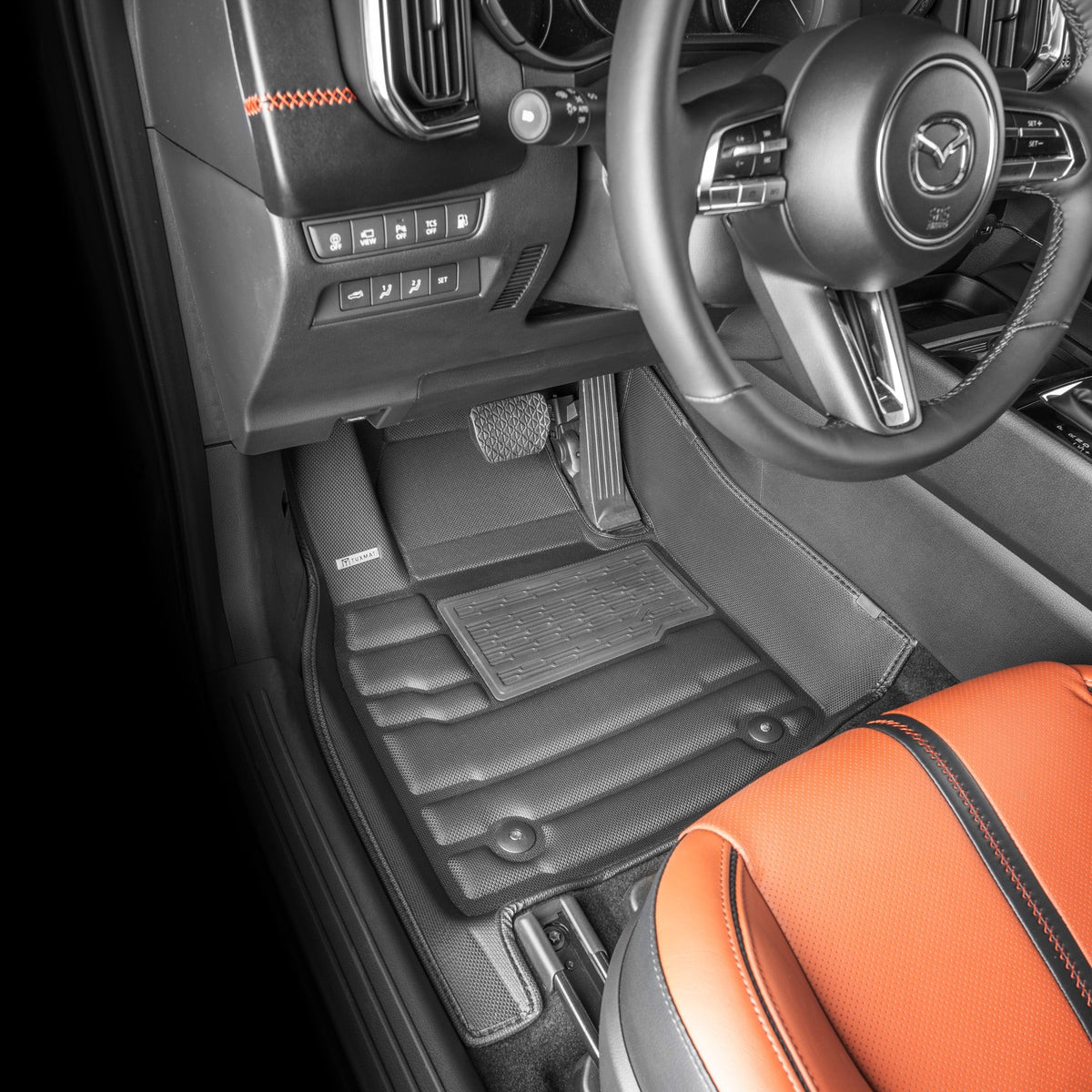 Car interior with orange seat and black floor mats